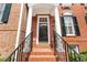 Townhome's front entrance with brick steps and black door at 4658 Ivygate Se Cir, Atlanta, GA 30339