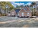 House exterior featuring stucco siding, a stone accent, and a spacious lawn at 20 Jasmine Ln, Oxford, GA 30054