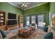 Living room featuring comfortable seating and large windows at 20 Jasmine Lane, Oxford, GA 30054