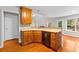 Kitchen with wooden cabinets, stainless steel appliances and hardwood floors at 2443 High Meadows Ct, Conyers, GA 30094