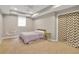 Basement bedroom with a full-size bed, hanging chair, and carpet flooring at 4024 Dream Catcher Dr, Woodstock, GA 30189