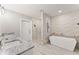 Elegant bathroom featuring a soaking tub, double vanity, and a walk-in shower at 6648 Garrett Rd, Buford, GA 30518