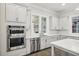 Gourmet kitchen with double ovens, stylish backsplash and stainless steel appliances at 105 Cumming St, Alpharetta, GA 30009