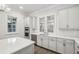 Bright kitchen with white cabinets, herringbone backsplash, and stainless steel appliances at 105 Cumming St, Alpharetta, GA 30009