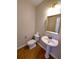 Clean bathroom with pedestal sink and wood floors at 600 Shadow Oaks Dr, Stone Mountain, GA 30087