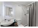 Basement bathroom with shower, gray curtain, and marble tile at 1283 Woodleigh Sw Rd, Marietta, GA 30008