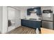 Basement kitchenette with navy cabinets and stainless steel appliances at 1283 Woodleigh Sw Rd, Marietta, GA 30008