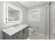 Updated bathroom with marble vanity and frameless shower at 1283 Woodleigh Sw Rd, Marietta, GA 30008