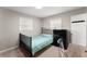 Well-lit bedroom with a full-size bed and dresser at 1283 Woodleigh Sw Rd, Marietta, GA 30008
