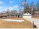 Brick ranch house with a two-car garage and landscaped yard at 1283 Woodleigh Sw Rd, Marietta, GA 30008