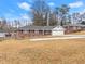Brick ranch house with a two-car garage and landscaped yard at 1283 Woodleigh Sw Rd, Marietta, GA 30008