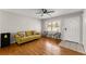 Living room with hardwood floors, a sofa, and entry door at 1283 Woodleigh Sw Rd, Marietta, GA 30008