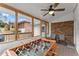 Screened porch with foosball table, ceiling fan, and backyard view at 1283 Woodleigh Sw Rd, Marietta, GA 30008