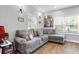 Spacious living room with gray sectional sofa and hardwood floors at 1174 Princess Sw Ave, Atlanta, GA 30310