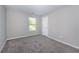 Simple bedroom with gray walls and gray carpeting at 6510 Boulder Rdg, Cumming, GA 30028