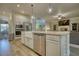 Open kitchen with island, farmhouse sink, and stainless steel appliances at 3109 Bentley Farms Dr, Loganville, GA 30052