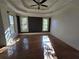 Bright bedroom featuring hardwood floors and a tray ceiling at 503 Champions Pt, Johns Creek, GA 30097