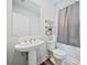 Clean and modern half bathroom with pedestal sink and gray walls at 608 Tiller Way # 33, Acworth, GA 30102