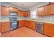 Kitchen with wood cabinets, granite countertops, and hardwood floors at 3680 Shale Ln, Conyers, GA 30013