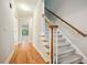 Staircase with hardwood floors and carpeted steps at 6650 Fairgreen Dr, Suwanee, GA 30024