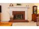 Brick fireplace with white mantel and hearth, offering a cozy focal point at 1131 Brogdon Dr, Powder Springs, GA 30127