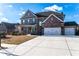 Brick two-story house with three car garage and landscaped yard at 1178 Fort Marcy Park, Lawrenceville, GA 30044