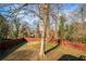 Large backyard with a mature tree and wooden fence at 884 N Eugenia Nw Pl, Atlanta, GA 30318