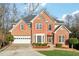 Two story brick home with landscaping, driveway and attached garage at 1211 Chadwick Point Dr, Lawrenceville, GA 30043