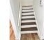 Modern staircase with dark brown steps and white risers at 4409 Idlewood Ln, Tucker, GA 30084