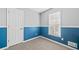 Small bedroom with blue accent wall and ample closet space at 87 Amber Ln, Dallas, GA 30157