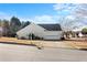 Rear exterior view with attached garage and driveway at 5642 Little Mill Pkwy, Buford, GA 30518