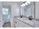 Bathroom with granite-topped double vanity and black matte fixtures at 8205 Kirk Sw St, Covington, GA 30014