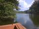 Serene lake view from a wooden boat, ideal for relaxing and enjoying nature at 8145 Stone Hill Rd, Cumming, GA 30028