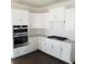 Modern kitchen with white cabinets, stainless steel appliances, and quartz countertops at 1999 Gladys Ct, Marietta, GA 30064