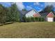 Side view of a charming house with a landscaped yard at 3009 River Garden Rd, Covington, GA 30016