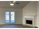 Living room with fireplace, French doors, and neutral carpet at 2712 Windsor Ct, Kennesaw, GA 30144