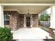 Brick front porch with a wooden door and decorative wreath at 965 Mulberry Bay Dr, Dacula, GA 30019