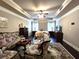 Main bedroom with sitting area and coffered ceiling, hardwood floors at 965 Mulberry Bay Dr, Dacula, GA 30019