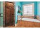 Bathroom features a walk-in shower, soaking tub, and a stained glass window at 3215 Kylee Dawn Cir, Lawrenceville, GA 30045