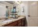 Double vanity bathroom with granite countertop and a large mirror at 3215 Kylee Dawn Cir, Lawrenceville, GA 30045
