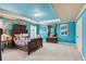 Spacious bedroom with antique bed frame and teal walls at 3215 Kylee Dawn Cir, Lawrenceville, GA 30045