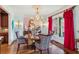 Elegant dining room features a crystal chandelier and seating for six at 3215 Kylee Dawn Cir, Lawrenceville, GA 30045