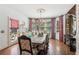 Elegant dining room features a rustic wood table, chandelier, and stylish patterned curtains at 3215 Kylee Dawn Cir, Lawrenceville, GA 30045