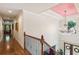 Grand hallway with hardwood floors, crystal chandelier, and an open-railing staircase at 3215 Kylee Dawn Cir, Lawrenceville, GA 30045