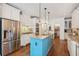 Modern kitchen with blue island, granite counters, and stainless steel appliances at 3215 Kylee Dawn Cir, Lawrenceville, GA 30045