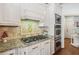 Kitchen features granite countertops, pineapple backsplash, and white cabinets at 3215 Kylee Dawn Cir, Lawrenceville, GA 30045