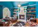Cozy library with a fireplace, leather furniture, and built-in shelves at 3215 Kylee Dawn Cir, Lawrenceville, GA 30045