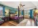 Large main bedroom with a four-poster bed, sitting area, and teal colored walls at 3215 Kylee Dawn Cir, Lawrenceville, GA 30045