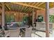 Covered patio with seating, dining area, and bar at 3215 Kylee Dawn Cir, Lawrenceville, GA 30045