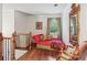 Elegant sitting area with chaise lounge, hardwood floors, and a large mirror at 3215 Kylee Dawn Cir, Lawrenceville, GA 30045